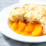 peach cobbler with buttery biscuit topping - featured image